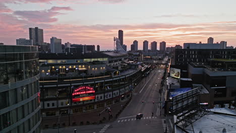 Aerial-pan-shot-in-front-of-the-Wrigley-Field-stadium,-colorful-dusk-in-Chicago