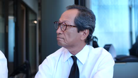 A-Japanese-businessman-is-listening-to-a-presentation-during-a-business-meeting