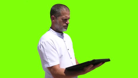 A-40-year-old-Industrial-worker-taps-on-a-tablet-and-then-presses-a-virtual-button-displayed-on-a-green-screen