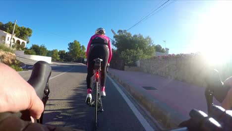 Road-cycling-training-young-girl-climbing-on-the-coast-road-early-morning-training-spin-in-winter