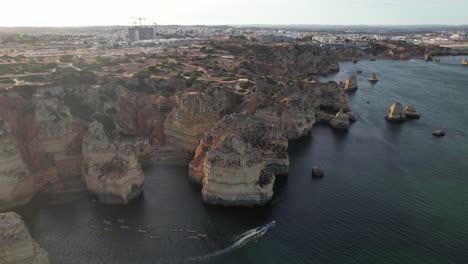 Aerial-Footage-From-Flying-Drone-Of-Tourist-Yachts-On-Clear-Blue-Water-In-Lagos,-Portugal