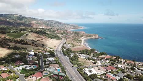 Palos-Verdes-California-Aerial-view-of-the-coast-line-overseeing-the-road-and-many-beautiful-homes-tech-blue-sky-water