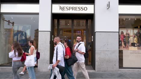 Pedestrians-and-shoppers-walk-past-the-Swiss-high-end-and-world-leader-in-coffee-capsules-brand-Nespresso-store