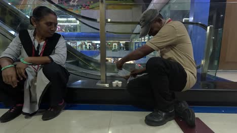 Security-guard-in-super-mall-drinking-tea-during-relax-time