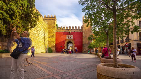 The-Moorish-old-city-walls-and-Real-Alcázar-gate-to-Seville,-Spain---time-lapse