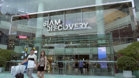 Front-side-of-Siam-Discovery-showing-the-entrance-and-exit-as-people-enter-and-go-out-of-this-classy-shopping-mall-in-Bangkok,-Thailand