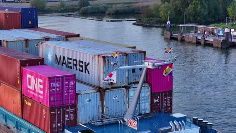 Vessel-full-of-containers-sailing-on-the-Noord-River-in-Netherlands,-aerial