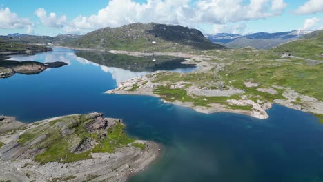 Mountain-Lake-along-Dyrskar-Tourist-Road-in-Hardangervidda,-Norway---Aerial