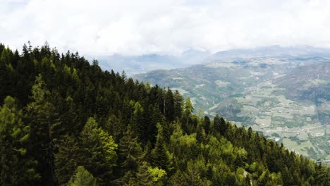 Aerial-view-overlooking-Italy's-roaming-hillsides-filled-with-trees
