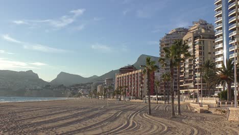 Calpe-beach-Spain-on-a-sunny-winter-afternoon-with-hotels-and-walkway