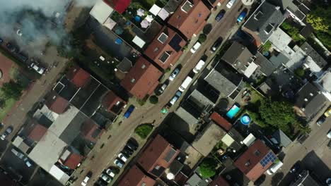 Aerial-shot-of-a-fire-burning-in-a-Dutch-shed-located-in-a-neighbourhood