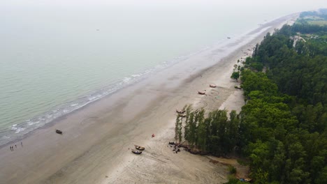 Tropical-Forest-Along-Sandy-Shore-Of-Kuakata-Sea-Beach-With-Fishing-Boats-In-Bangladesh,-South-Asia