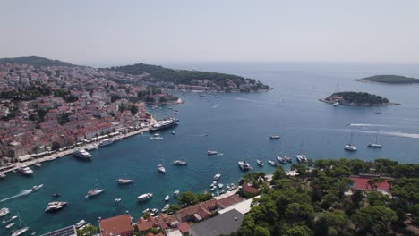 Scenic-high-angle-drone-view-over-Hvar-port-with-lots-of-boat-traffic,-Croatia