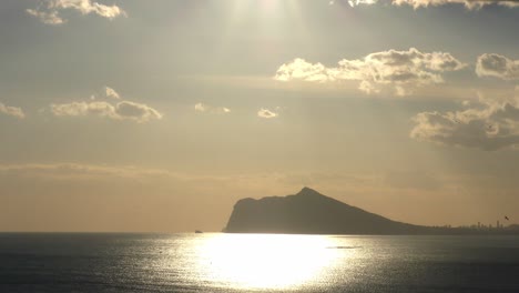 Calpe-Spain-late-evening-sunshine-from-Pena-De-Ifac-with-the-skyline-of-Benidorm-in-the-distance