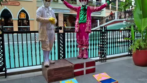 Costumed-mimes-are-a-popular-attraction-at-this-Venice-themed-commercial-complex-in-Bonifacio-Global-City,-Philippines,-which-features-luxury-brand-stores,-international-food-bazaars,-gondola-rides