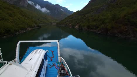 Serenity-on-Koman-Lake-in-Albania,-a-Peaceful-Journey-with-a-Ferry-Through-Stunning-Alpine-Mountains-and-Tranquil-Waters