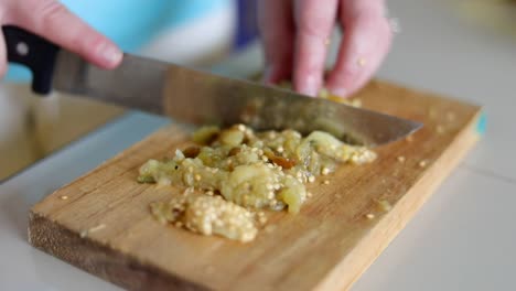 Chopping-up-Fried-Eggplant---Close-Up
