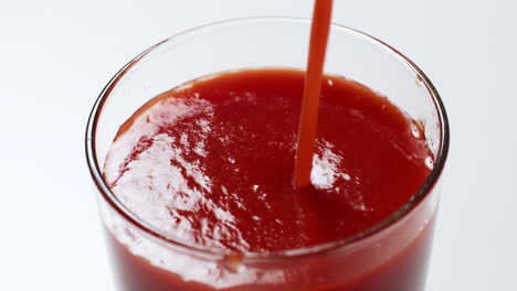 Filling-a-tall-glass-up-to-its-brim-with-a-cold-and-fresh-tomato-juice