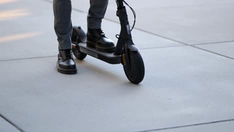 close-up-shot-of-a-businessman-arriving-with-his-e-scooter