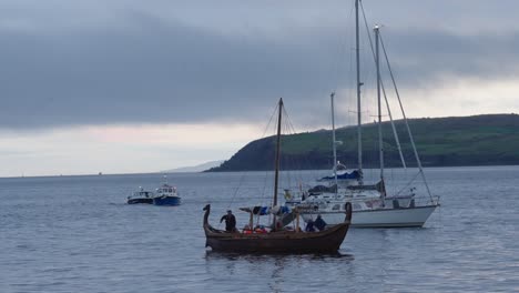Replica-Viking-ship-and-other-vessels-are-moored-off-the-coast-of-Largs,-Scotland