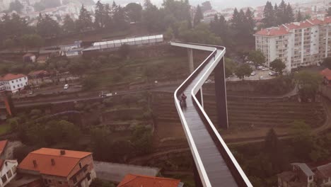 An-aerial-drone-shot-of-a-long-and-narrow-bridge-in-Portugal-on-a-bad-rainy-day-weather