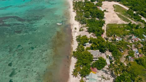 Turquoise-and-tropical-waters-along-Bayahibe-Beach,-La-Romana-in-Dominican-Republic