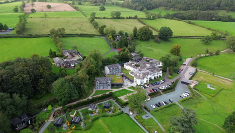 Aerial-footage-of-boutique-hotel-in-the-Lake-District-surrounded-by-fields-and-farmland