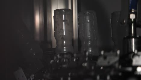 Plastic-Bottles-Upside-Down-on-a-Conveyor-Belt-Line-at-a-Factory-Being-Sterilised-for-Preparation-at-a-Vinegar-Factory
