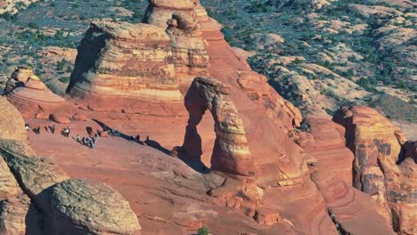 Arches-National-Park-With-Tourists-Exploring-Its-Scenic-Landscape---aerial-drone-shot