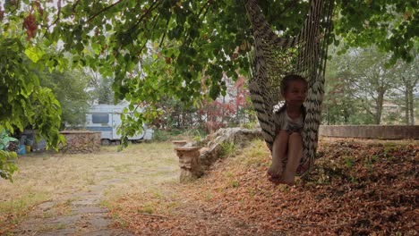 Time-to-relax-as-a-young-female-child-swings-on-a-hammock-under-a-tree