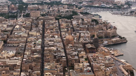 Aerial-view-flying-around-the-downtown-of-Valletta-city,-cloudy-evening-in-Malta
