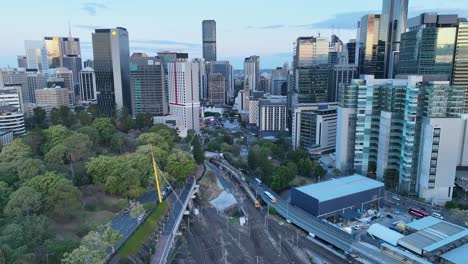 Aerial-shot-of-train-coming-out-of-tunnel-leading-into-Brisbane-City-Central-Station