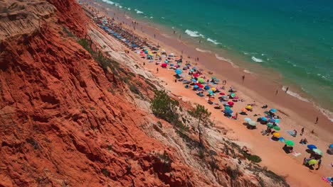People-enjoying-a-day-at-Praia-Da-Falesia-Beach,-Algarve,-Portugal