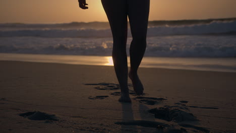 girl-walks-away-from-the-sea-at-sunset