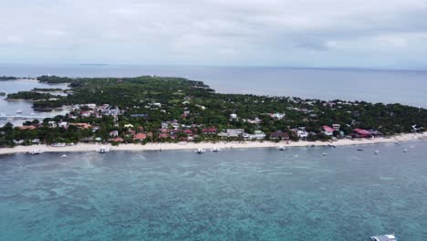 Aerial-long-shot-of-Malapascua-Island-with-Bounty-beach-and-diving-Boats-in-foreground,-Philippines