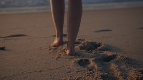 girl-walking-towards-the-sea-golden-hour-sunset-slow-motion-shot