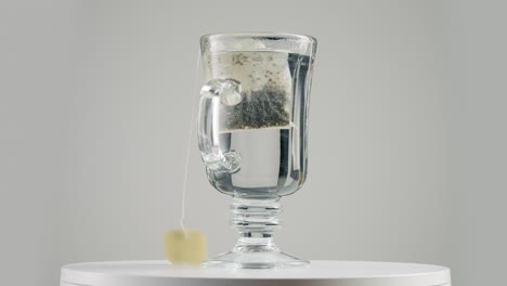 Putting-Tea-Bag-on-the-Glass-on-the-Spinning-Table