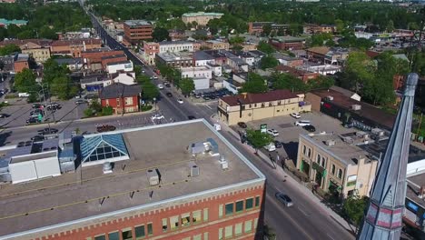 All-Saints-Spire-with-Background-Traffic-Along-Dundas-Street-from-an-Aerial-Drone-Shot-Above-the-Town-of-Whitby-in-Ontario,-Canada