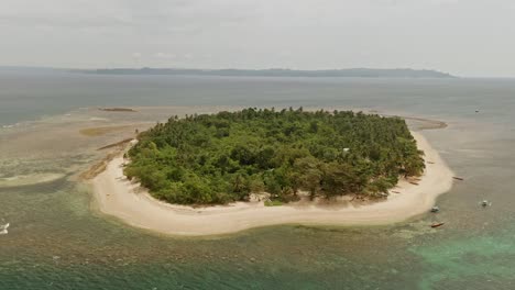 Steady-locked-off-shot-of-Alingkakajaw,-aka-Aling-island-is-a-tropical-deserted-paradise-just-off-the-coast-of-Claver-in-Surigao-Del-Norte,-Philippines