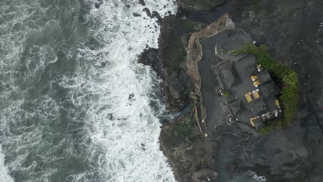 Aerial-looks-directly-down-on-Tanah-Lot-Temple-on-rocky-Bali-seashore