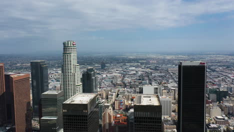 Aerial-tracking-shot-in-front-of-skyscrapers-in-sunny-downtown-Los-Angeles,-USA