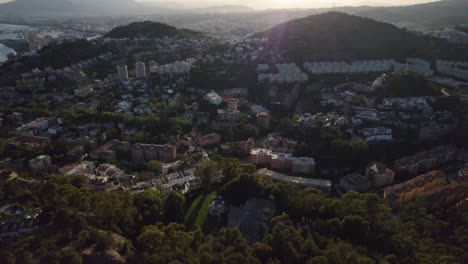 Low-angle-sunlight-aerial-view-over-Mediterranean-city-Malaga,-Spain
