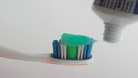 Toothpaste-being-applied-on-a-toothbrush.-Close-up