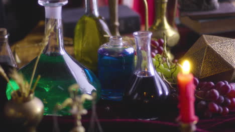 Elixir-Gótico-Renacentista:-Botellas-Variadas-Sobre-Una-Mesa---Drama-De-Vestuario