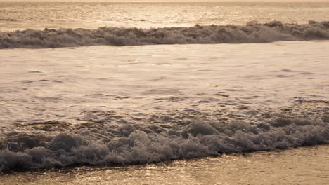 Slowmotion-small-sea-water-waves-come-to-sand-beach-Bali-Indonesia-close-up-tele