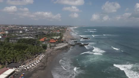 Aerial-flight-over-Megada-Beach-on-south-coast-of-Bali,-rock-outcrops