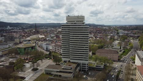 Aerial-dolly-in-of-city-hall-tower,-shopping-mall-and-Kaiserslautern-downtown-skyline-cityscape,-Germany