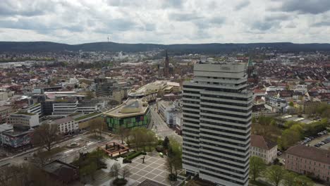 Aerial-dolly-in-of-Kaiserslautern-downtown-with-its-high-city-hall-building,-shopping-mall-and-churches