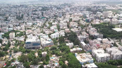Afternoon-in-4K-Aerial-footage-of-Hyderabad,-Telangana,-India's-urban-residential-and-commercial-hubs-Hill-Top-Colony,-Banjara-Hills,-and-Khairtabad