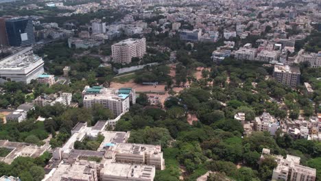 Aerial-footage-of-India's-urban-residential-and-commercial-centres-in-Hyderabad,-Telangana-a-house,-a-terrace,-hotels,-and-some-trees-are-shown